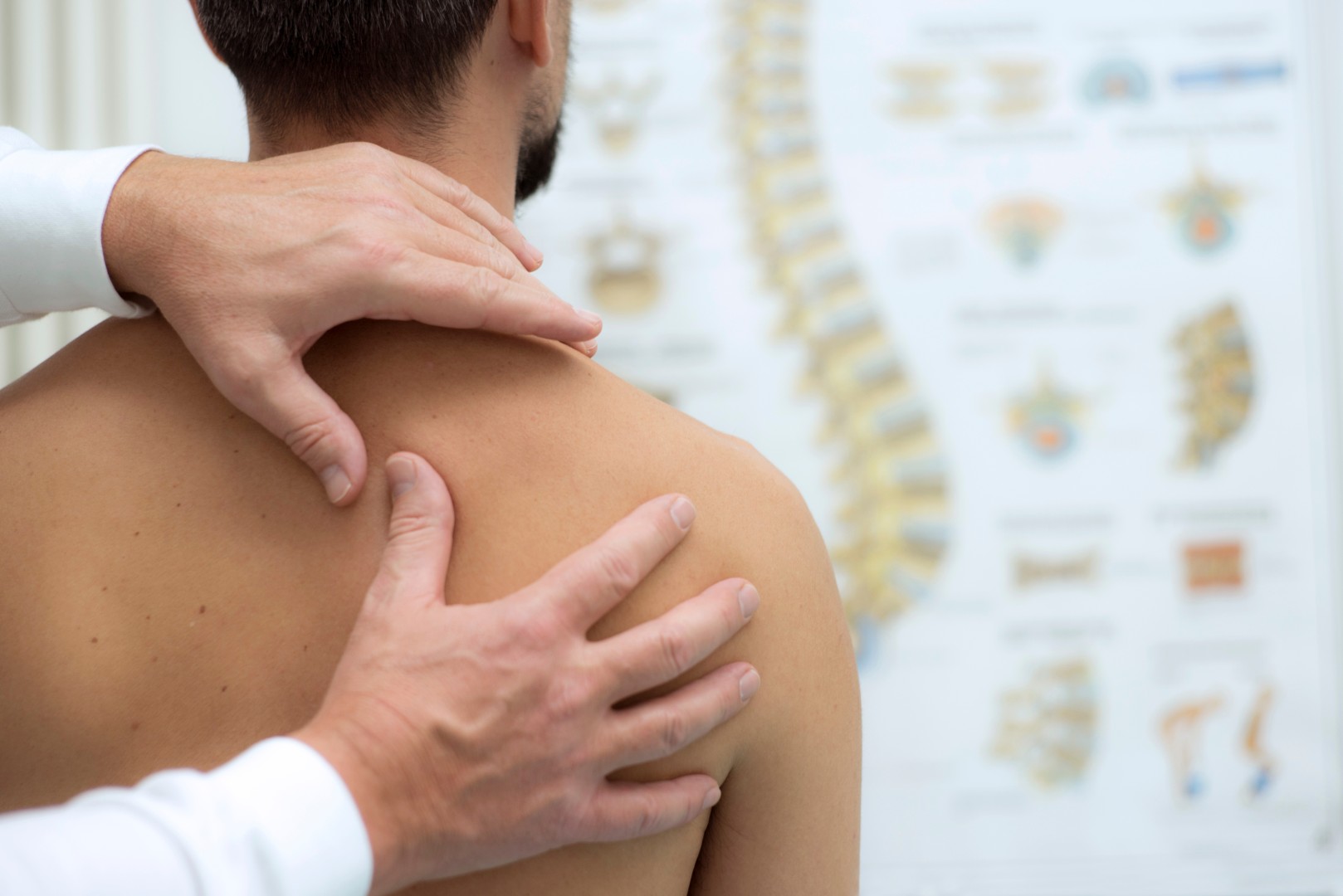 Physio checking shoulder blade