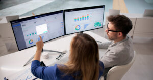 Corporate Team Working Together With Enterprise ERP Software For Financial And Operational Management
